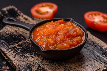 Red hot or spicy sauce with chili peppers, tomatoes, garlic, spices