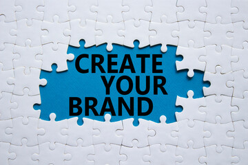 Create your Brand symbol. Concept words Create your Brand on white puzzle. Beautiful blue background. Business and Create your Brand concept. Copy space.