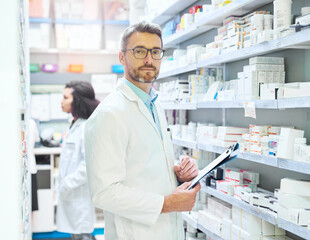 Pharmacist, portrait and man with clipboard by shelf for inventory, information or medical record. Pharmacy, drugs and mature person with checklist of pills for healthcare, dispensary and storage