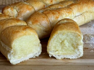 Fresh bread baked on the table. Creamy garlic bread with cheese.