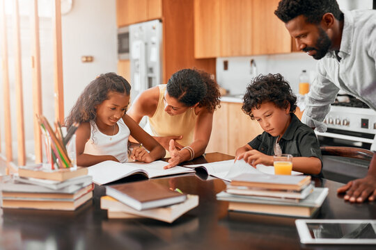 Family, children and books with homework for learning, guidance or help on kitchen table. Mother, father and young kids studying together for education, knowledge or childhood development at house