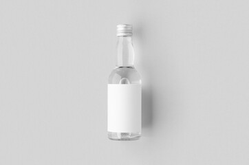 Miniature spirits, liquor bottle mockup. Clear glass and liquid with a blank label.