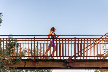 Woman running on a bridge outdoors