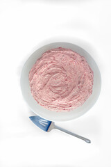 Strawberry, homemade pink cake from above, with silver cake cutter on white background, verticle