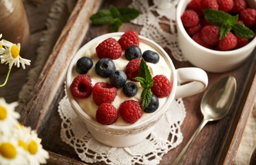 A cup of cottage cheese blended with flax seed oil, with fresh raspberries and blueberries. Budwig diet.
