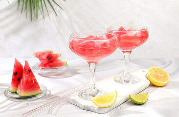 Watermelon frozen margarita cocktail with fresh slices of watermelon, lime and mint, summer party and vacation concept, bar advertising, cafe, selective focus.