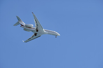 Private jet against the blue sky as it approaches Nice, France