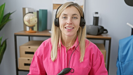 Smiling woman with headphones in a bright office representing customer support.