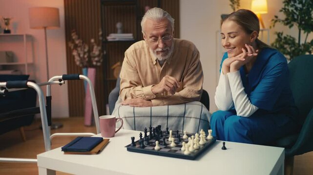 Elderly man playing chess with young nurse, memory training games for seniors