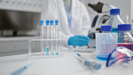 Fototapeta premium A focused scientist wearing a lab coat and gloves conducting experiments in a well-equipped laboratory