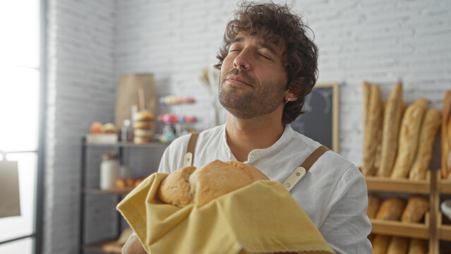 Young man enjoying freshly baked bread in a cozy bakery interior with shelves full of assorted pastries.