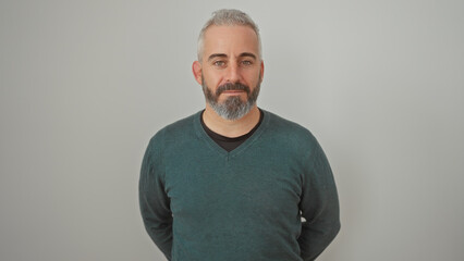 A confident, middle-aged man with a beard and casual attire stands against a plain white background. © Krakenimages.com