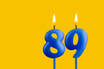 Blue candle number 89 - Birthday on yellow background