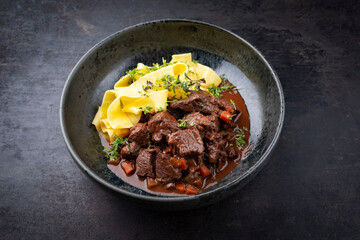 Traditionelles deutsches geschmortes Hirschragout mit Gemüse und Tagliatelle Pasta in süß...