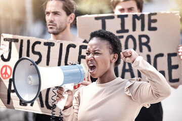 Frustrated black woman, megaphone and protest with crowd for human rights, equality or change in society or city. Angry African, female person or activist screaming on loudspeaker in riot or rally