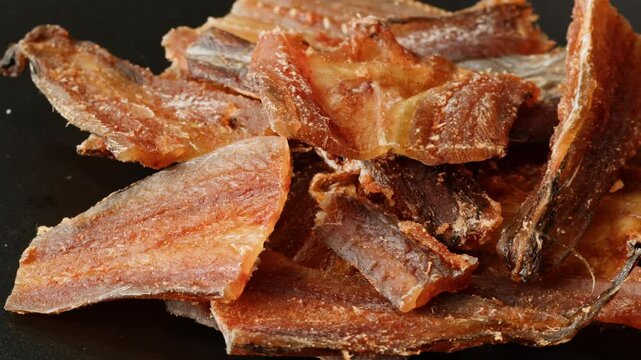 Dry fish snack for beer and drinks with paprika close-up. The yellowstripe scad is commonly used as a dried fish snack in Asian countries, processed either by salting, curing or mechanical drying