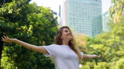 portrait of a young beautiful woman in the park enjoying the warm weather in spring or summer