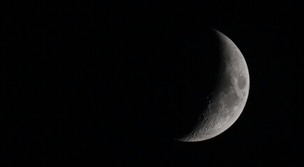 Close up picture of waxing crescent moon in dark sky