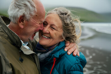 Happy retired couple walking along the ocean coast