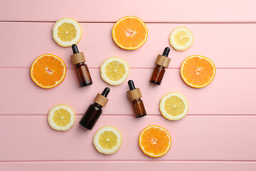 Aromatherapy. Different essential oils and citrus fruits on pink wooden table, flat lay