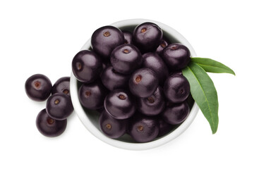 Fresh ripe acai berries in bowl and green leaves isolated on white, top view