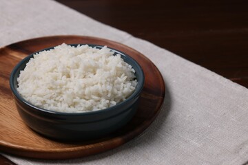 Delicious boiled rice served on table. Space for text