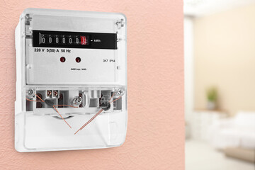 Electricity meter on wall indoors, space for text. Measuring device