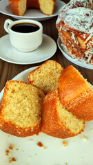 Breakfast table with cakes and coffee on the wooden table
