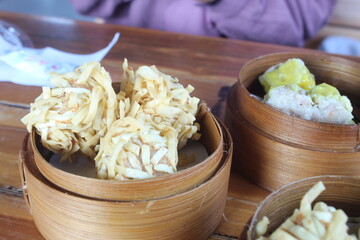 Tulungagung, Indonesia Oktober 25, 2024: Rambutan Shrimp or Crispy Dimsum Chinese Dumplings Layered with Shrimp with Noodles. one of the menus at the Gacoan noodle restaurant. Served with Sauce