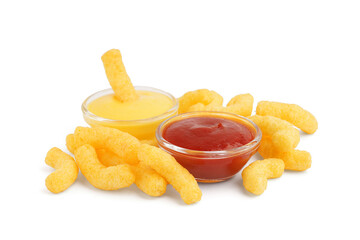Tasty salty corn sticks and sauces on white background