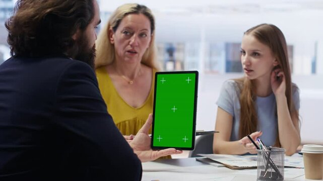 Broker holding green screen tablet, meeting with clients to provide stock exchange analysis. Financial advisor with chroma key device looking at market shares, helping family maximize income, camera B