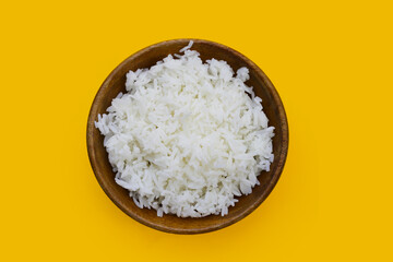 Cooked rice in bowl on yellow background.