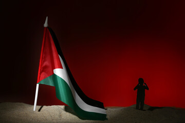 Child silhouette with flag of Palestine on sand against red background. Sorrow concept