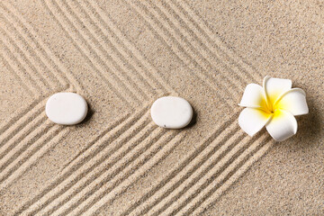 Stones and plumeria on sand. Zen concept