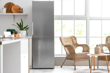 Interior of modern kitchen with refrigerator