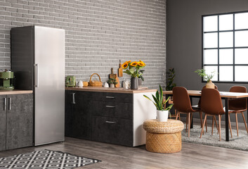 Stylish interior of modern kitchen with big refrigerator