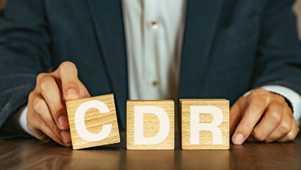 There is wood cube with the word CDR. It is an abbreviation for Carbon Dioxide Removal as...