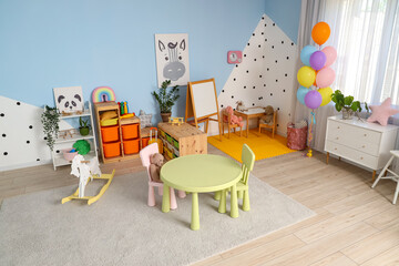 Stylish interior of modern playroom in kindergarten