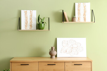 Pictures on chest of drawers and shelves in living room