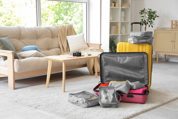 Packed suitcase with belongings on floor at home. Travel concept