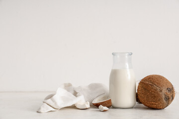 Bottle of fresh coconut milk on white background
