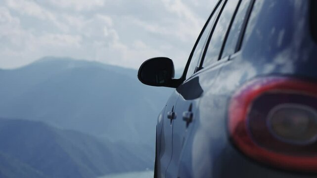 Suv traveler adventure car is parked on high altitude viewpoint with amazing panoramic view of Kozjak lake in Macedonia and mountain range canyon