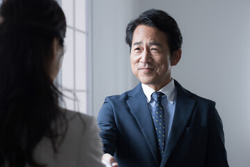 Executive businessman shaking hands at contracts, business meetings, etc.