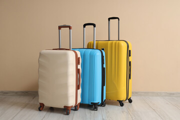 Packed suitcases near beige wall