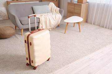 Packed white suitcase in interior of living room