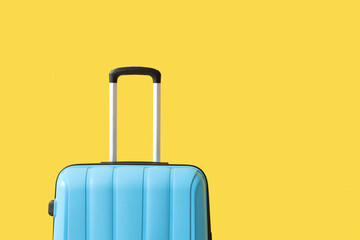 Packed suitcase near yellow wall