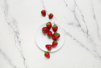 Plate with fresh sweet strawberries on white background