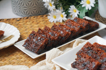 Kek Buah Kukus, a traditional Malaysian steamed fruit cake filled with dried fruits, nuts, and spices, enjoyed during celebrations.