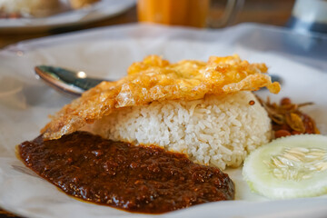 Close up of Nasi lemak, a Malay style complete meal of fragrant rice cooked in coconut milk.