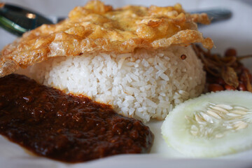 Close up of Nasi lemak, a Malay style complete meal of fragrant rice cooked in coconut milk.
